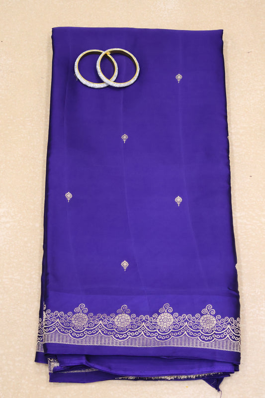 Blue saree with white embroidery on a beige background